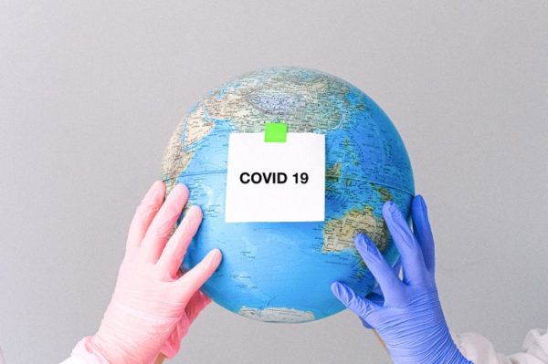 hands-with-latex-gloves-holding-a-globe-4167559_Fotor